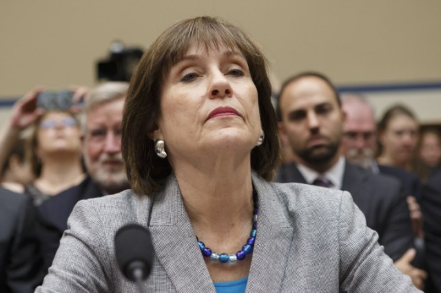 FILE - In this May 22, 2013 file photo, Internal Revenue Service official Lois Lerner refuses to answer questions as the House Oversight Committee holds a hearing to investigate the extra scrutiny the IRS gave Tea Party and other conservative groups that applied for tax-exempt status, on Capitol Hill in Washington. A House committee is voting whether to hold the former Internal Revenue Service official in contempt of Congress for refusing to answer questions at a pair of hearings. Lerner previously headed the IRS division that processes applications for tax-exempt status. (AP Photo/J. Scott Applewhite, File)