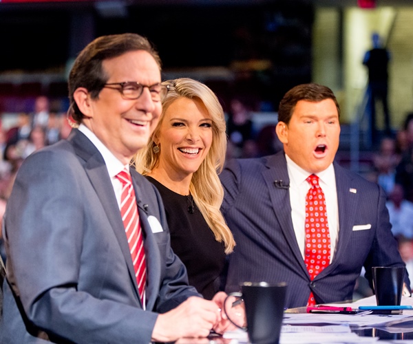 Fox News moderators from left, Chris Wallace, Megyn Kelly and Bret Baier speak to the camera before Republican presidential candidates New Jersey Gov. Chris Christie, Sen. Marco Rubio, R-Fla., Ben Carson, Wisconsin Gov. Scott Walker, Donald Trump, former Florida Gov. Jeb Bush, former Arkansas Gov. Mike Huckabee, Sen. Ted Cruz, R-Texas, Sen. Rand Paul, R-Ky., and Ohio Gov. John Kasich take the stage for the first Republican presidential debate at the Quicken Loans Arena, Thursday, Aug. 6, 2015, in Cleveland. (AP Photo/Andrew Harnik)