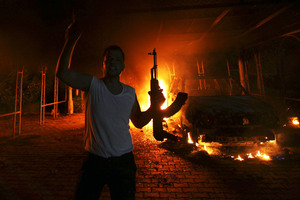 File photo of protester reacting as the U.S. Consulate in Benghazi is in flames
